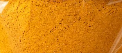 Close-up of Shri Gopal Ji turmeric powder, seen through the pouch window