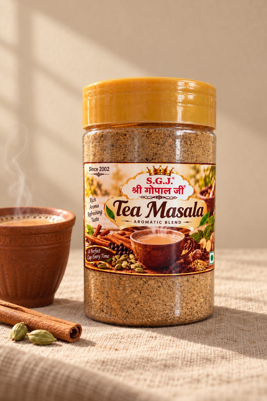 A clay cup of masala chai beside a jar of Shri Gopal Ji tea masala